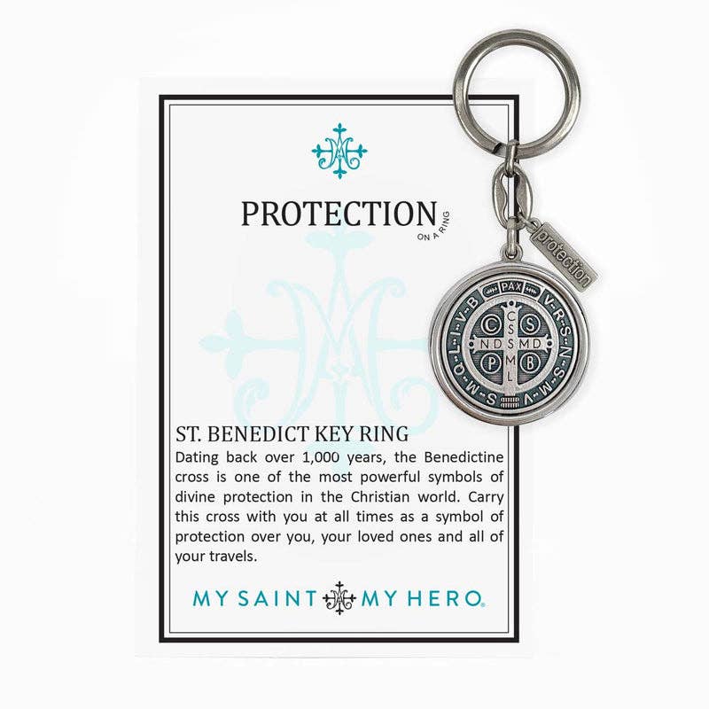 The display card for St. Benedict Key Chain that reads Protection on a Ring, and talks about the St. Benedictine cross, featuring the My Saint My Hero logo at the bottom of the cars.