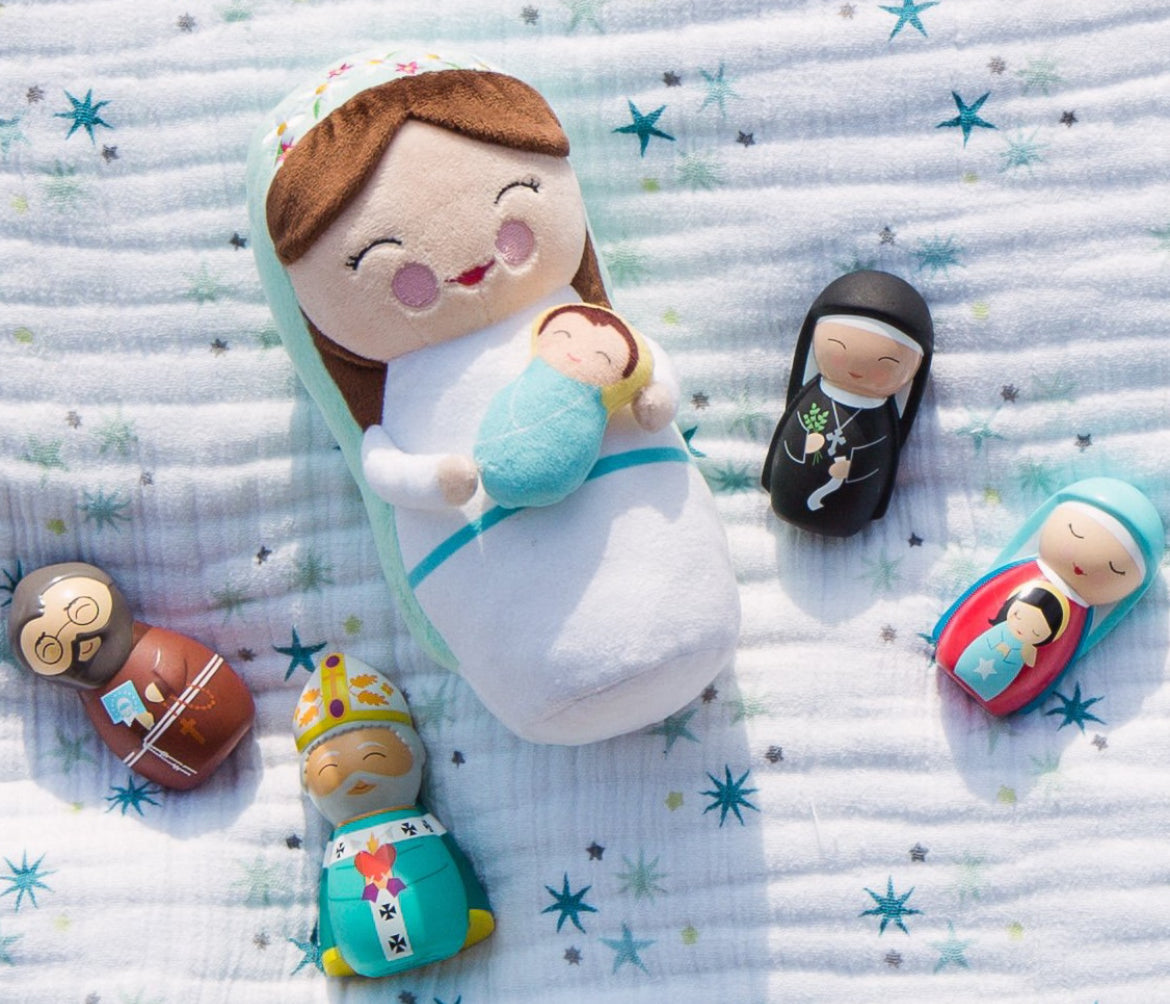 A plush doll featuring Mary, mother of Jesus, surrounded by smaller Saint play dolls