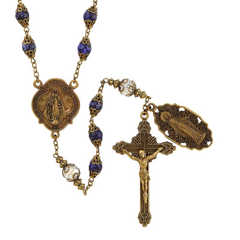 Rosary in antique gold finish featuring both dark blue and crystal beads and two medals featuring Mary, Mother of Jesus.