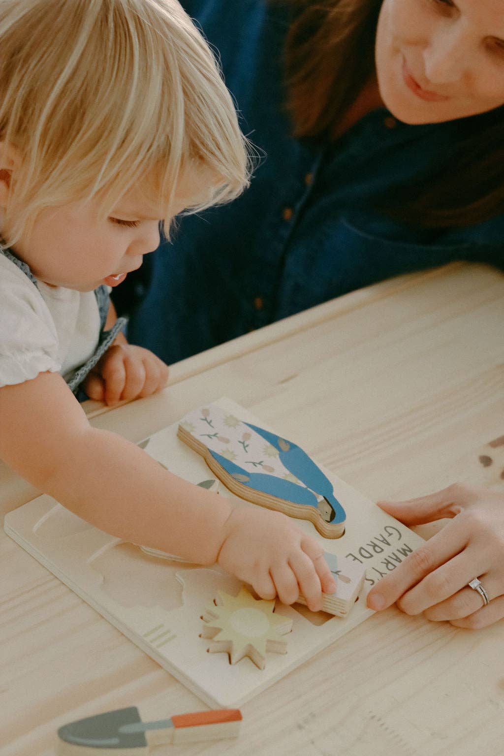 A child playing with Mary’s garden puzzle