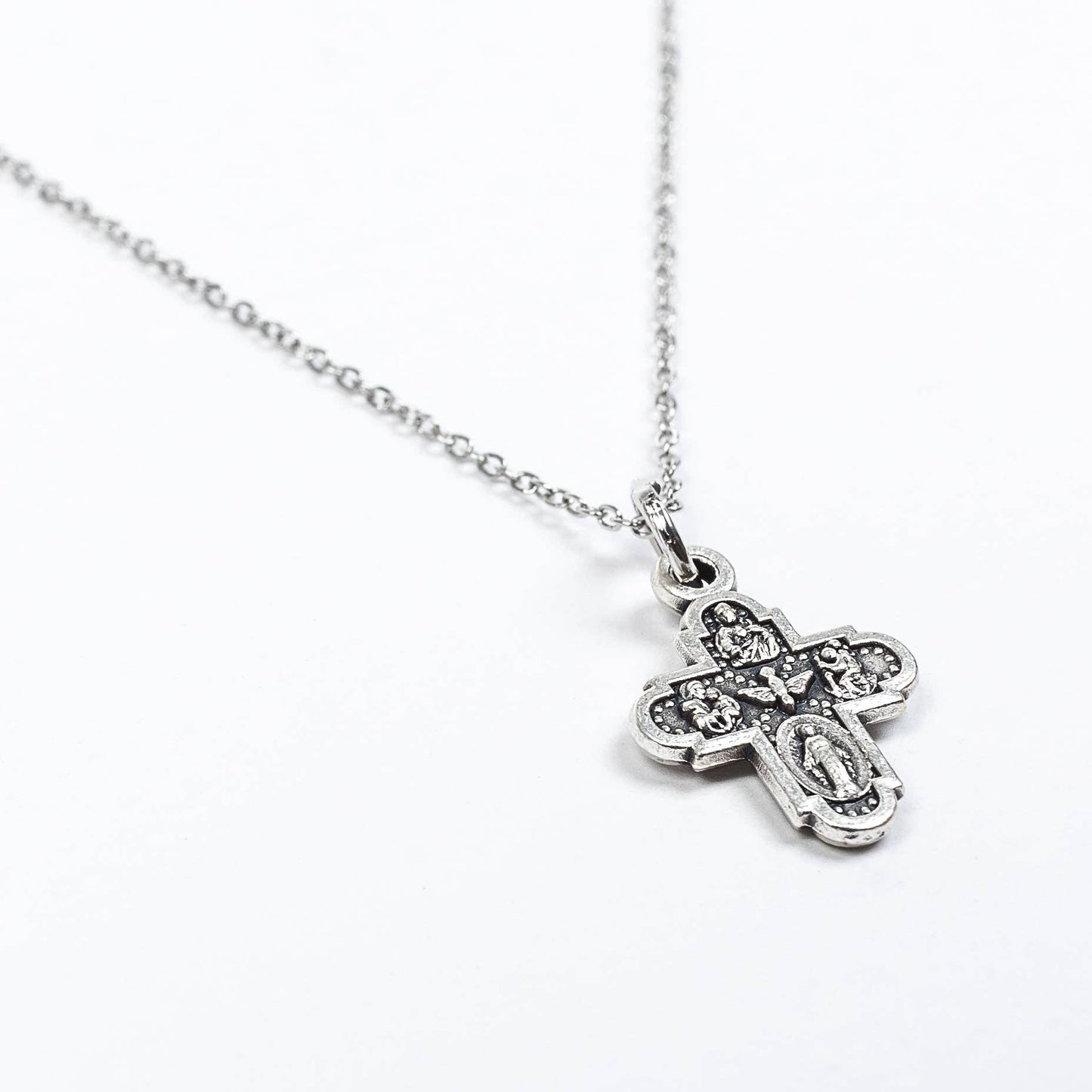 A silver 4-way cross chain necklace close up