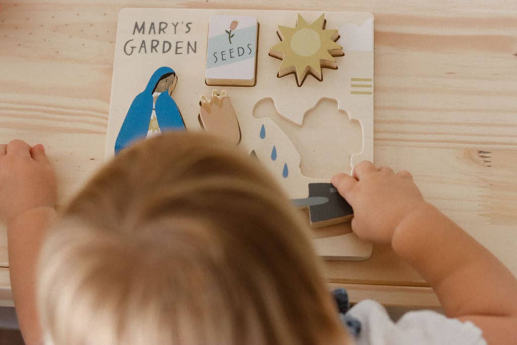 A child playing with Mary’s garden puzzle