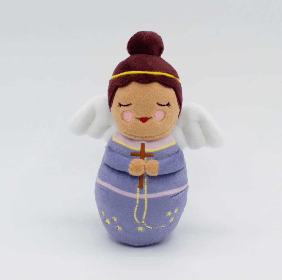 A guardians angel plush doll wearing a purple dress