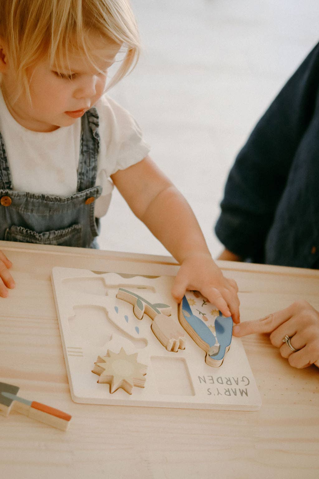 A child playing with Mary’s Garden Puzzle