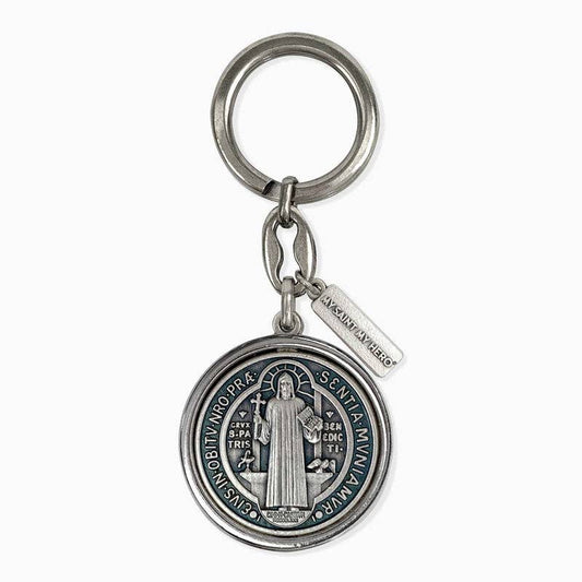 The front side of a silver St. Benedict keychain.