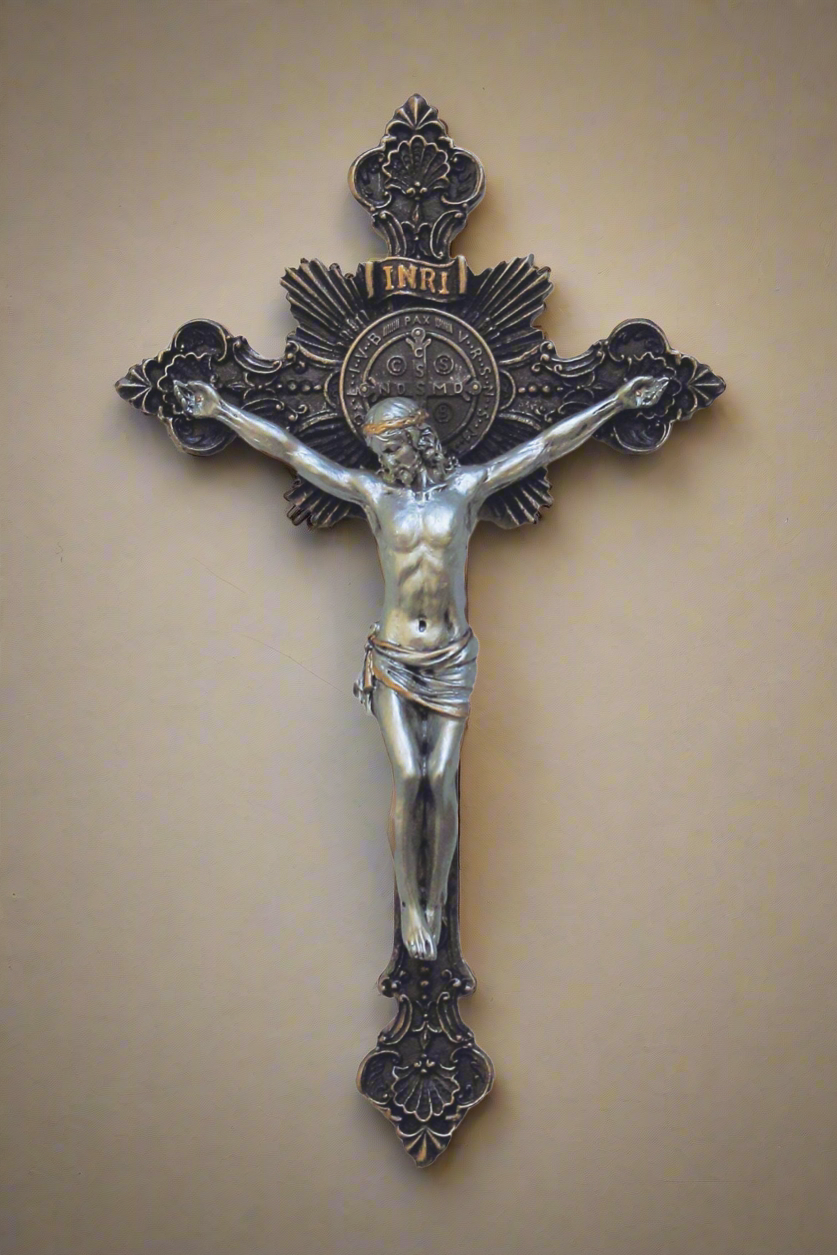 An ornate Bronze Cross featuring a St. Benedict medal behind the head of Jesus that is in a silver finish. Above Jesus's head it reads "INRI"