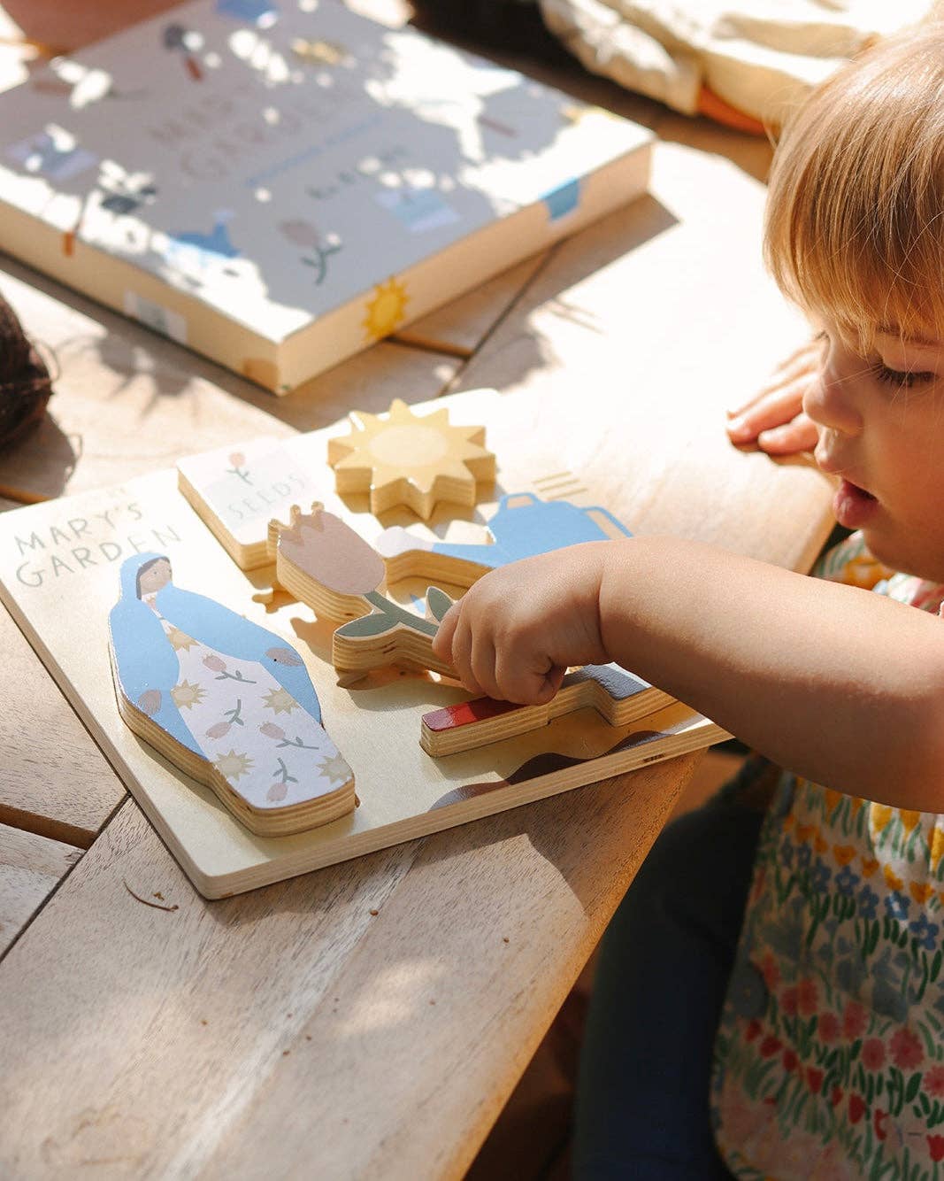 A child playing with Mary’s garden puzzle