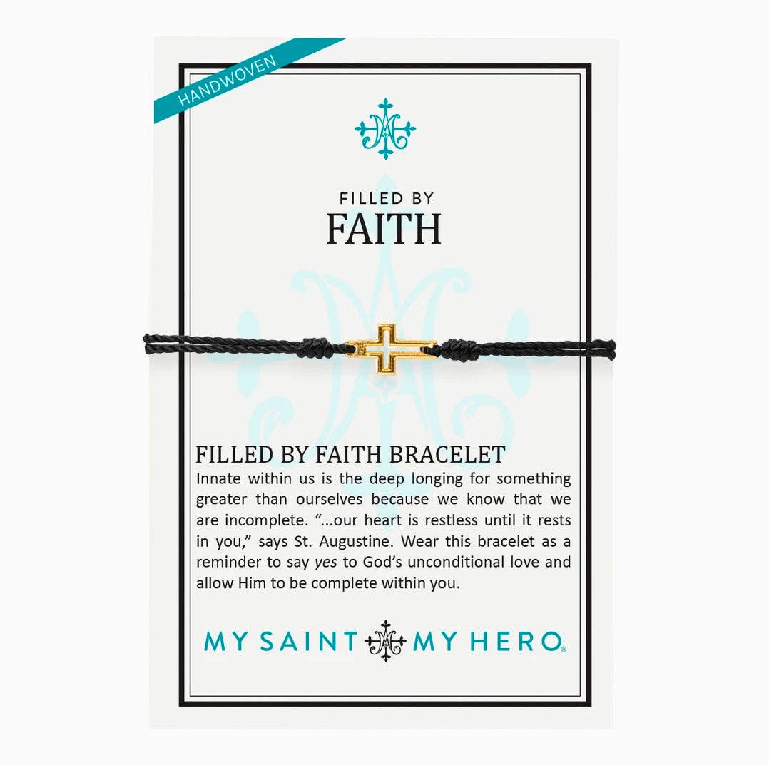 The display card for a pull bracelet featuring a gold cross outline.  Display card reads "Handwoven", "Filled by Faith", talks about the bracelet, and has the My Saint My Hero logo at the bottom of the display card. 
