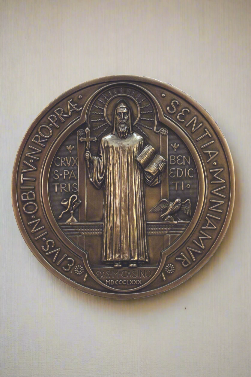 The front side of a St. Benedict Plaque in a bronze finish.