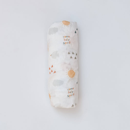 An rolled-up baby blanket in a white color featuring triangles, dove, sun and words that read "Come Holy Spirit"