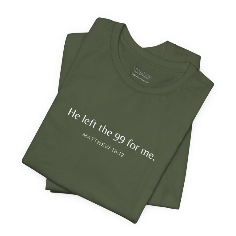 A folded army green shirt that reads "He left the 99 for me. Matthew18:12"