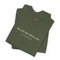 A folded army green shirt that reads "He left the 99 for me. Matthew18:12"