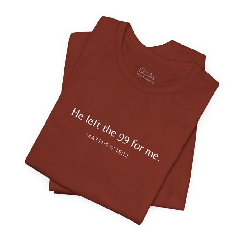 A folded rust-colored shirt that reads "He left the 99 for me. Matthew18:12"