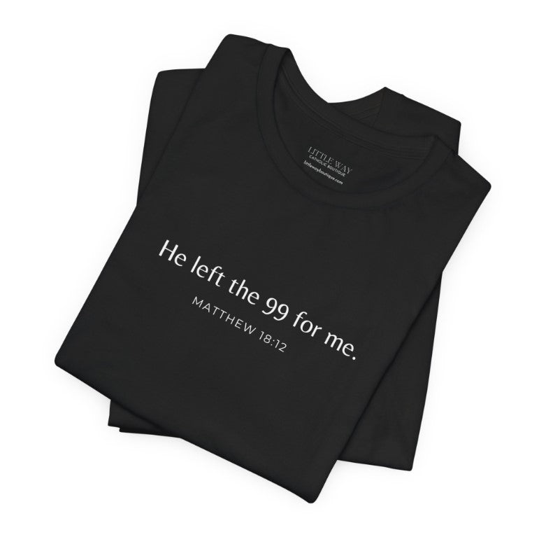 A folded black shirt that reads "He left the 99 for me. Matthew18:12"