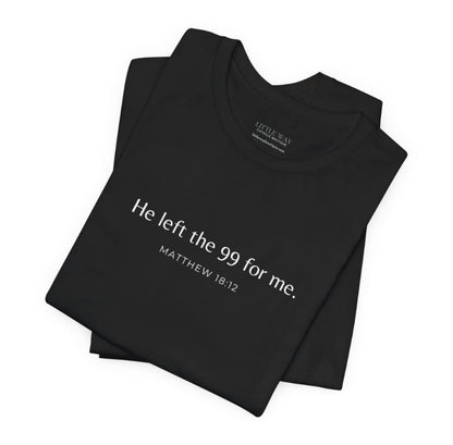 A folded black shirt that reads "He left the 99 for me. Matthew18:12"