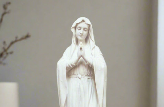 Adorning Virgin Mary Statue in white finish. Mary has her hands together in prayer. 