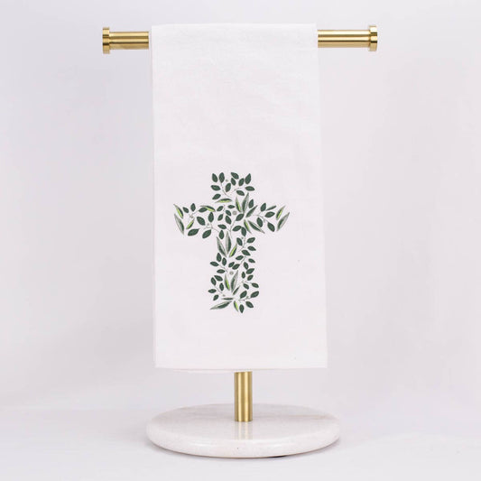 A hand towel featuring a cross out of greenery, displayed on a towel stand.
