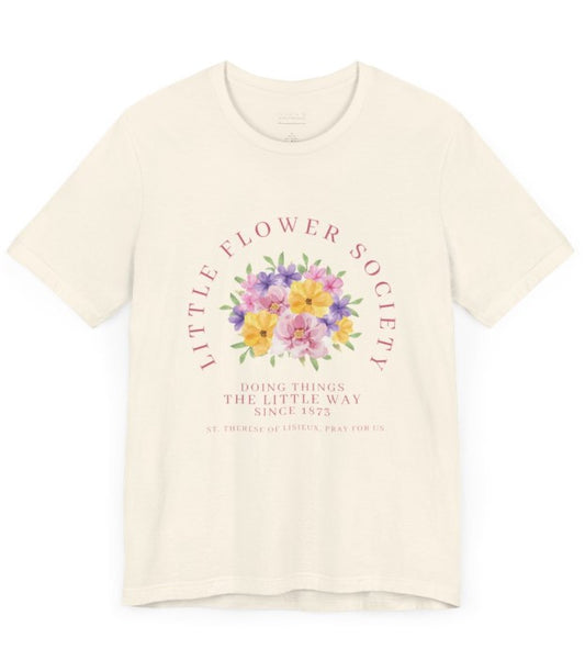 An off-white shirt that reads "Little Flower Society" and "Doing things the Little Way since 1873" and "St. Therese of Lisieux, Pray for us." with a floral image in center.