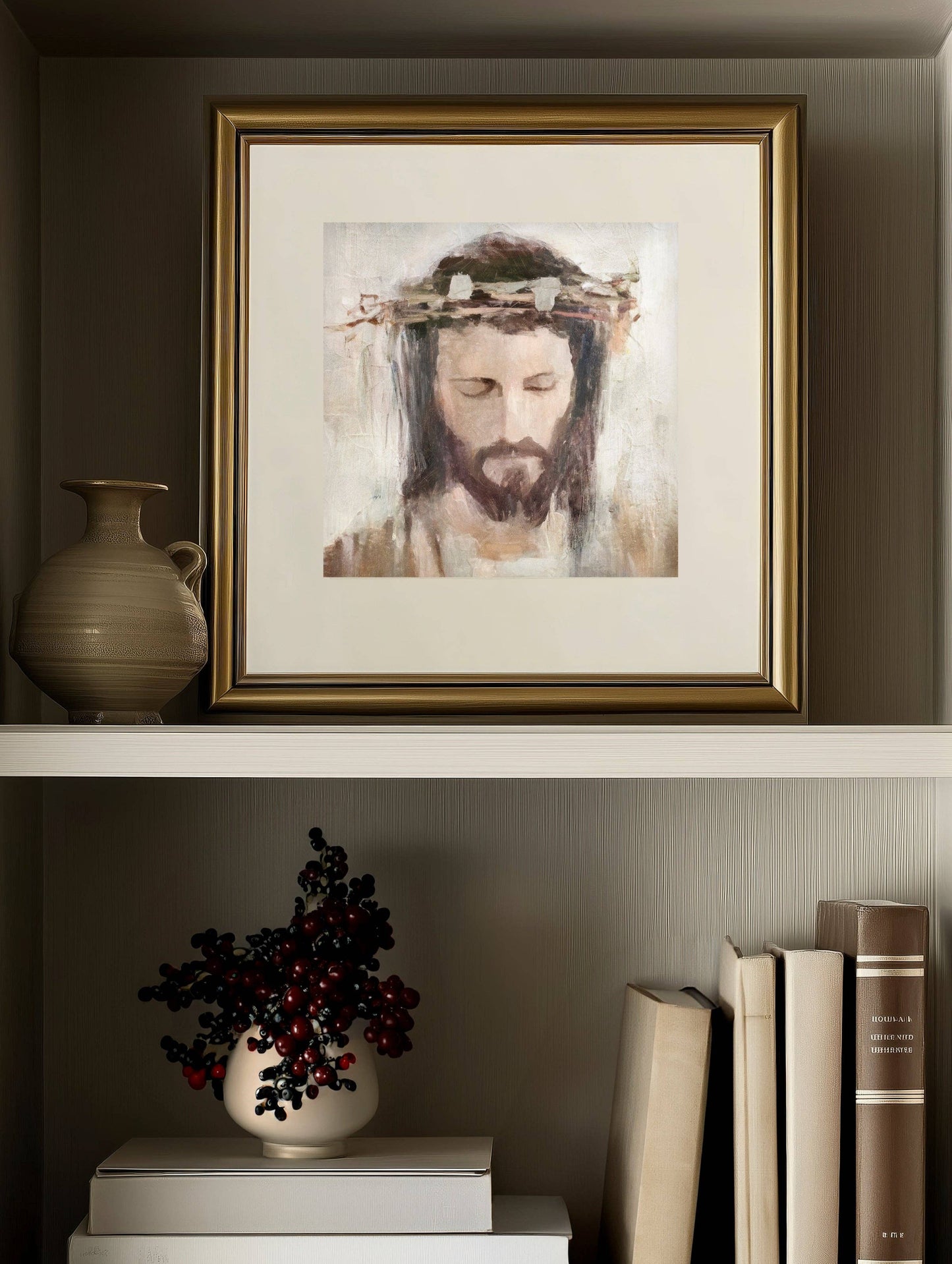 A bookshelf with books, plant, vase, and a framed art print of a Crowned Jesus in a gold frame.