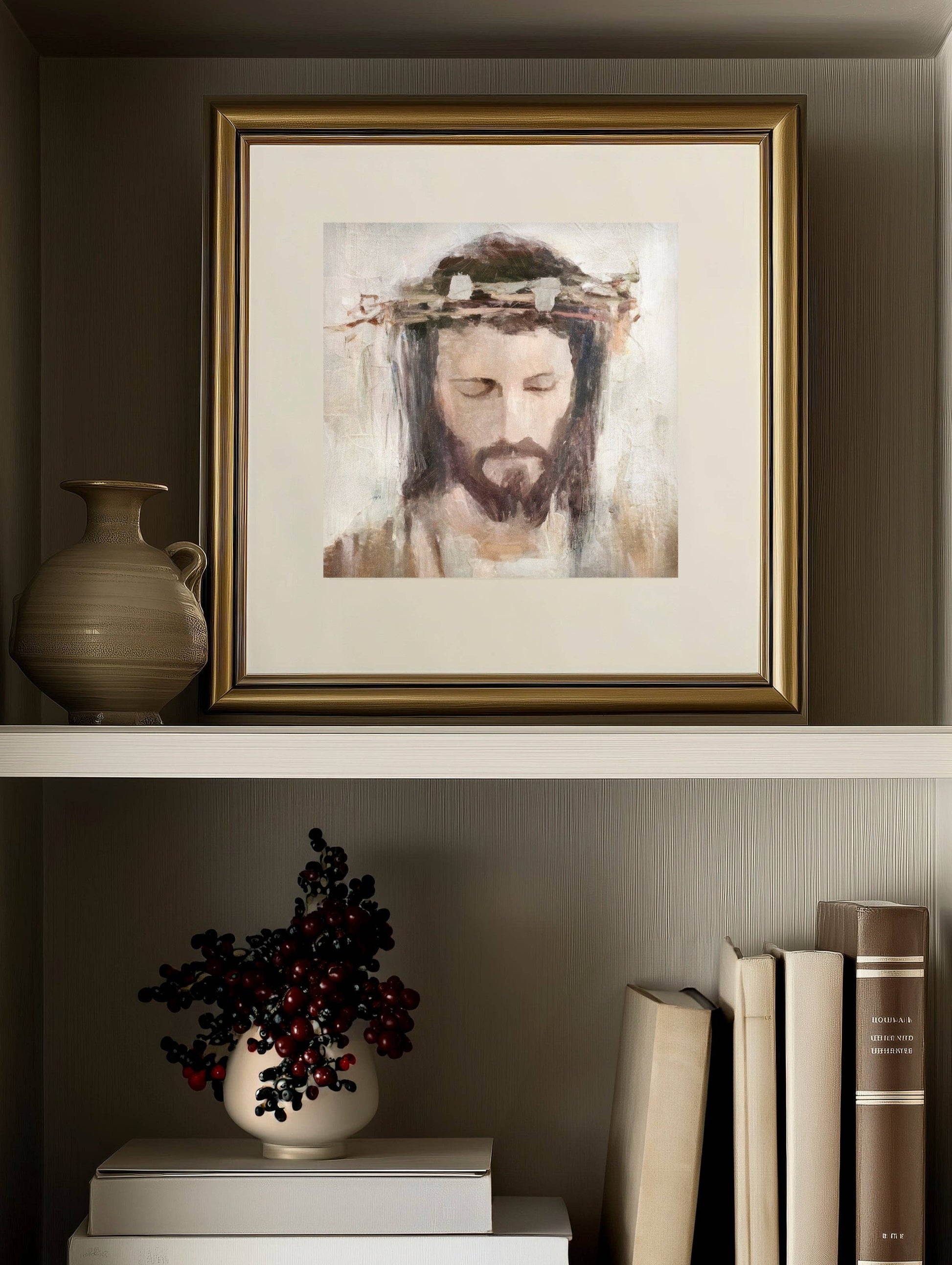 A bookshelf with books, plant, vase, and a framed art print of a Crowned Jesus in a gold frame.