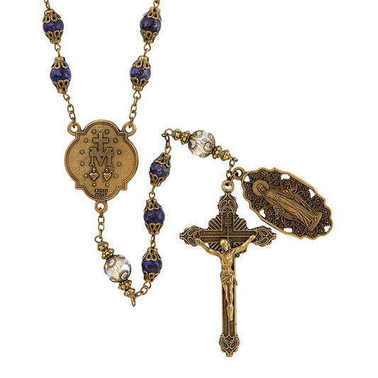 Rosary in antique gold finish featuring both dark blue and crystal beads and two medals featuring Mary, Mother of Jesus and the Marian Miraculous medal with two sacred hearts.