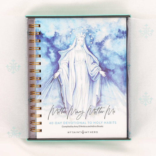 A 40-Day Devotional to Holy Habits, "Mother Mary, Mother Me" compiled by Amy D'Ambra and Adina Braatz from My Saint My Hero.  The devotional is a spiral bound book with Mother Mary on the cover in a white image on a blue cloud background.